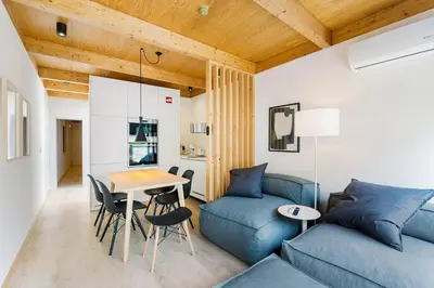 a living room with a blue couch and a table at GuestReady - Cedofeita Collection Apartments in Porto