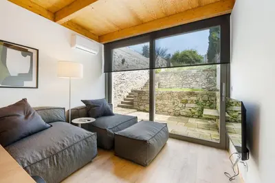 a living room with a couch and a large window at GuestReady - Cedofeita Collection Apartments in Porto