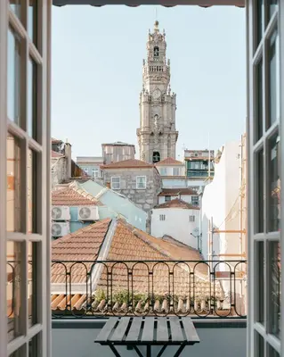 a bedroom with a view of a clock tower from a window at Panoramic Historic Views Private Terrace - Apt G in Porto
