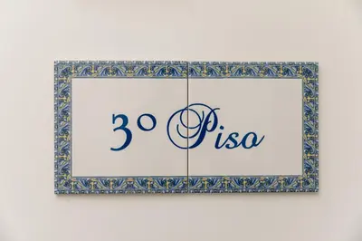 a framed picture of the uso on a wall at Clérigos Apartments Porto - Ferradores in Porto