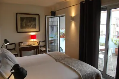 a bedroom with a bed and a view of a patio at Penthouse Inn Bolhão in Porto
