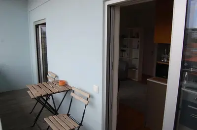 a table and chairs in a room with a kitchen at Penthouse Inn Bolhão in Porto