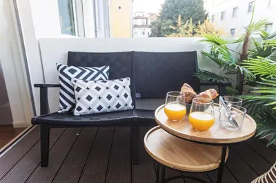 two tables with glasses of orange juice on a balcony at Porto Gallery District Escape, Central Retreat in Porto