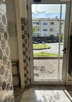 a table and two chairs in front of a window at Casa da Praceta in Porto