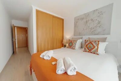 a bedroom with a white bed with towels on it at Stylish Flat by Hosty in Porto