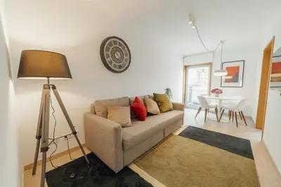 a living room with a couch and a table at Stylish Flat by Hosty in Porto