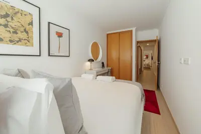 a white living room with a couch and a mirror at Stylish Flat by Hosty in Porto