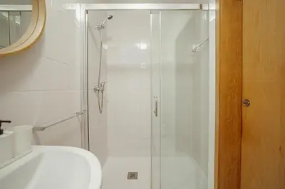 a bathroom with a shower with a toilet and a sink at Stylish Flat by Hosty in Porto
