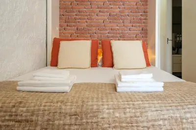 a bedroom with a bed with towels on it at Historic Porto Nook Downtown Porto near metro in Porto