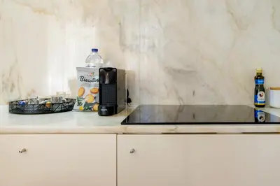 a coffee maker and a bottle of water on a counter at Historic Porto Nook Downtown Porto near metro in Porto