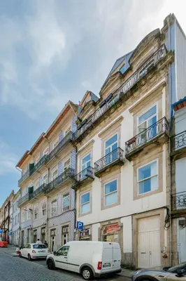 a white van parked in front of a building at Historic Porto Nook Downtown Porto near metro in Porto