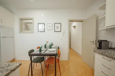 a kitchen and a dining room with a table and chairs at City Center Comfort Apartment by Vacationy in Porto