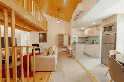 a loft conversion of a house with a living room at City Center Comfort Apartment by Vacationy in Porto