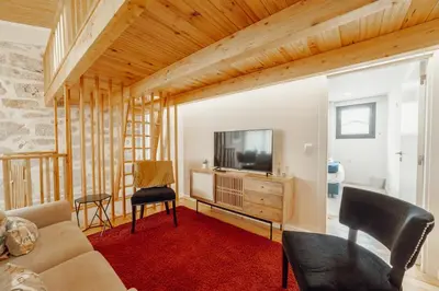 a room with a table and a blue chair at City Center Comfort Apartment by Vacationy in Porto