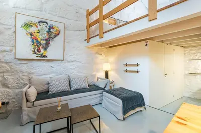 a living room with a couch and a painting on the wall at GuestReady - A special place in Porto in Porto