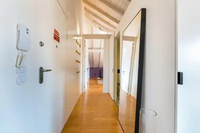 a hallway with white walls and a mirror at GuestReady - A Porto Nest with a Twist in Porto