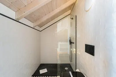 a bathroom with a glass shower and a toilet at GuestReady - A Porto Nest with a Twist in Porto