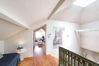 an attic bedroom with a bed and a staircase at VIVA Loft in Historic Center Porto in Porto