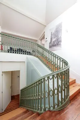 a staircase in a house with a green railing at VIVA Loft in Historic Center Porto in Porto
