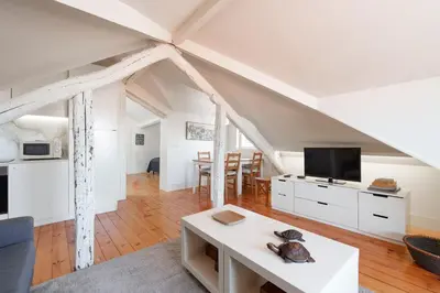 a living room with white furniture and a table at VIVA Loft in Historic Center Porto in Porto