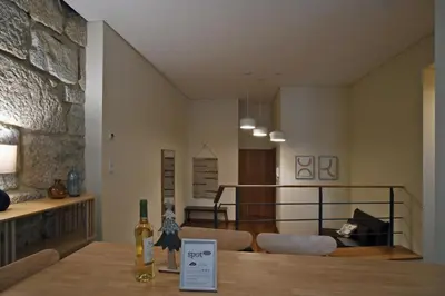 a room with a table with a bottle of wine on it at Spot Apartments Sao Bento in Porto