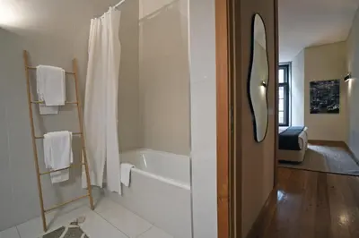 a bathroom with a bath tub and a shower at Spot Apartments Sao Bento in Porto