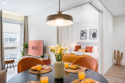 a living room with a bed and a table with food at GuestReady - Unfolded in Porto