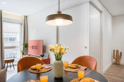 a dining room with a table with orange juice at GuestReady - Unfolded in Porto