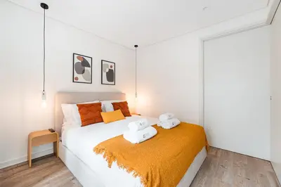 a bedroom with a bed with two towels on it at GuestReady - Unfolded in Porto