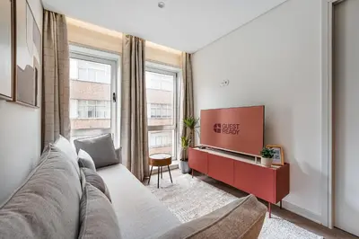 a living room with a couch and a desk at GuestReady - Unfolded in Porto