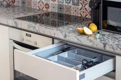 an open drawer in a kitchen with a sink at Santa Teresa Studio by LovelyStay in Porto