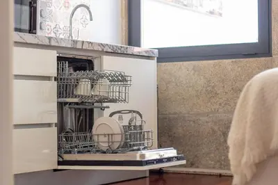 a dishwasher in a kitchen with dishes in it at Santa Teresa Studio by LovelyStay in Porto