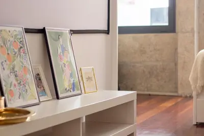 a white counter with paintings on it in a room at Santa Teresa Studio by LovelyStay in Porto