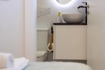 a bathroom with a sink and a toilet at Quiet Duplex w Patio in Lapa by LovelyStay in Porto