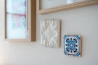 a mirror and a plate on a wall at GuestReady - Clérigos Tiles House in Porto