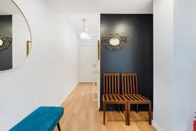 a living room with a chair and a mirror at GuestReady - Peaceful retreat near Casa da Música in Porto