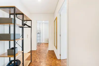 a hallway with a staircase and a room with white walls at GuestReady - Peaceful retreat near Casa da Música in Porto