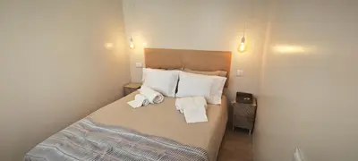 a bedroom with a bed with towels on it at Apartamento D'Alegria in Porto