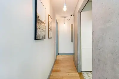 a hallway with white walls and wood floors at GuestReady - Lovely home in Campanhã in Porto