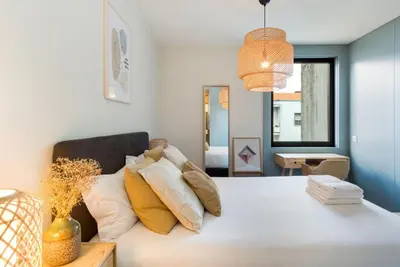 a bedroom with a bed with pillows on it at GuestReady - Lovely home in Campanhã in Porto