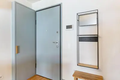 a glass door in a room with a mirror at GuestReady - Lovely home in Campanhã in Porto