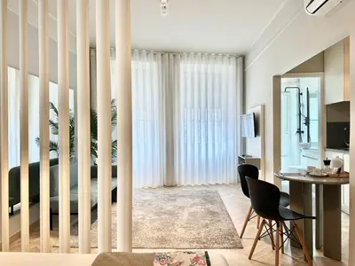 a living room with a bed and a table and chairs at YOUROPO - Capela in Porto