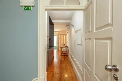 a hallway with a door leading to a kitchen at YOUROPO - Capela in Porto