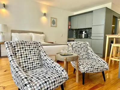 a living room with two chairs and a bed at YOUROPO - Capela in Porto