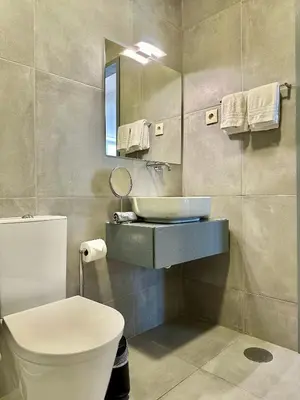 a bathroom with a sink and a toilet and a mirror at YOUROPO - Capela in Porto