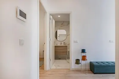a bedroom with a bed with a lamp and towels on it at The Superior Green @ BoaVista Flats in Porto