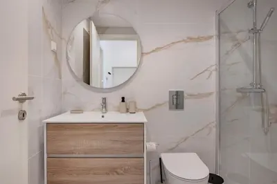 a white bedroom with a bed with a lamp on it at The Superior Green @ BoaVista Flats in Porto