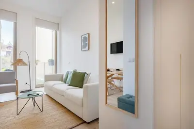 a white living room with a white couch and a table at The Superior Green @ BoaVista Flats in Porto
