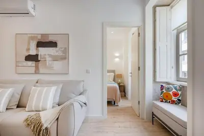 a desk with a chair and a lamp on it at The Soft Escape @ BoaVista Flats in Porto