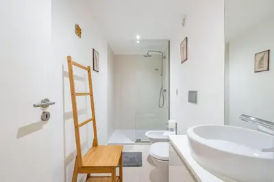 a bathroom with a sink and a toilet and a ladder at GuestReady - Dolce experience in Porto in Porto